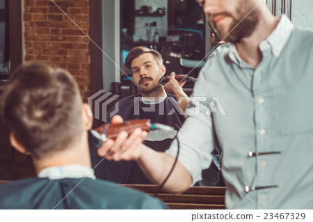 Hipster client visiting barber shop Hipster client visiting barber shop 23467329