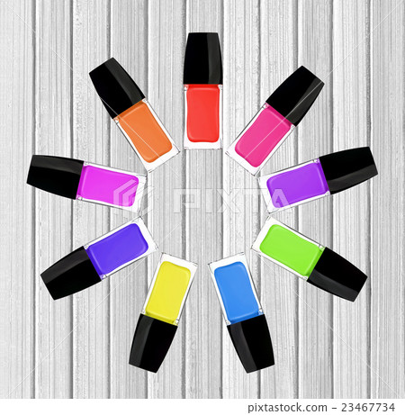 set of colorful nail polishes on white wood table 23467734
