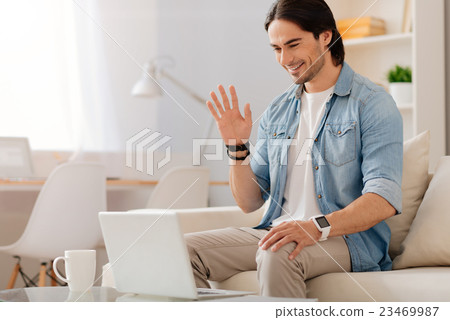 Positive smiling man talking through the Internet 23469987