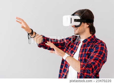 Positive man using virtual reality device Positive man using virtual reality device 23470220