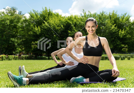 Positive women doing sport exercises outdoors Positive women doing sport exercises outdoors 23470347