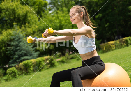 Positive woman doing sport exercises Positive woman doing sport exercises 23470362