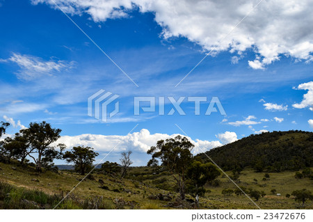 Rural landscape with mountains & overcast blue sky 23472676