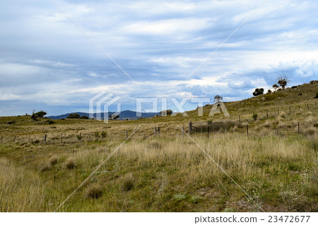 Rural landscape with mountains & overcast blue sky Rural landscape with mountains & overcast blue sky 23472677