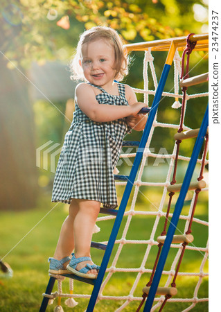 The little baby girl playing at outdoor playground 23474237
