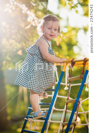 The little baby girl playing at outdoor playground 23474243