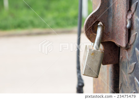close up of key on steel door close up of key on steel door 23475479