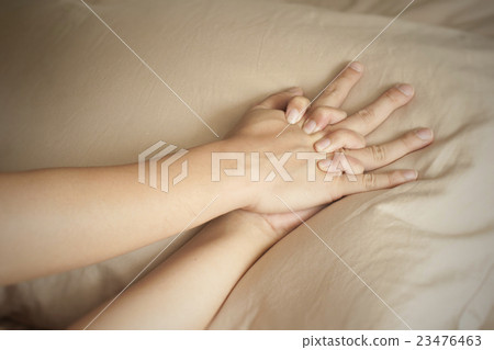Close up hands of a couple having sex on a bed Close up hands of a couple having sex on a bed 23476463