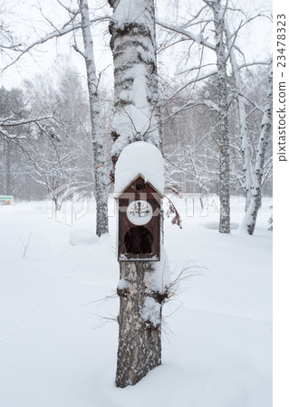 Birdhouse in the winter forest 23478323