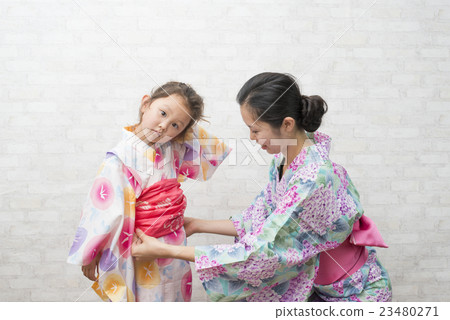 A mother dressed in a yukata for her daughter A mother dressed in a yukata for her daughter 23480271