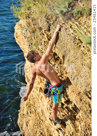 climber hanging by a cliff 23481415