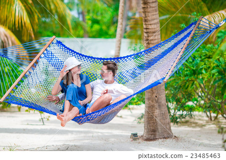 Family on summer vacation relaxing in hammock 23485463