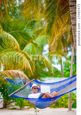 Man Relaxing In Hammock Man Relaxing In Hammock 23485475