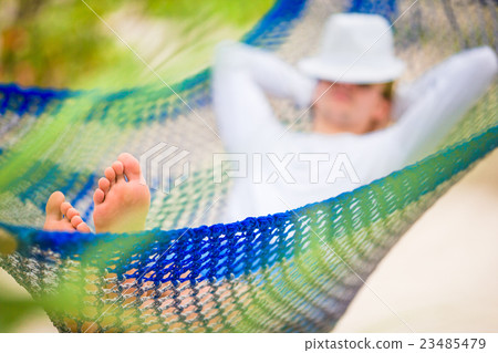 Lazy time. Man in hat in a hammock on a summer day 23485479