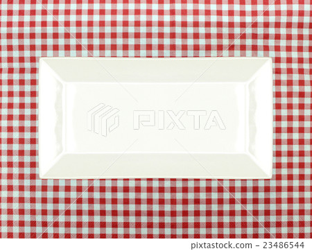 the plate on checkered tablecloth 23486544