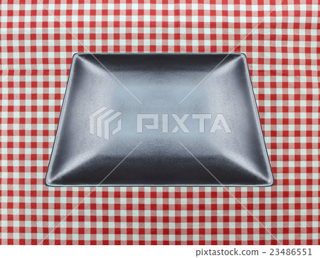 the plate on checkered tablecloth 23486551