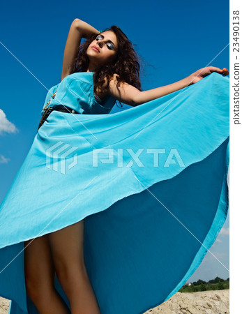 Beautiful brunette girl in blue dress Beautiful brunette girl in blue dress 23490138