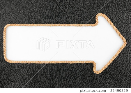 Arrow made of rope  lies on a background leather 23490839