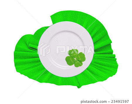 plate on green napkin with clover leaf  23491597