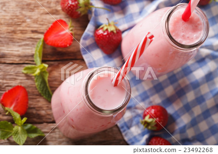 Fresh strawberry milkshake in glass bottles 23492268