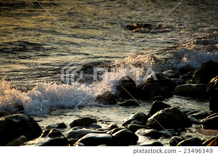 Wave splashing over rocks Wave splashing over rocks 23496349