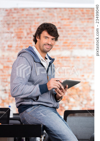 Man using tablet computer casual businessman smile Man using tablet computer casual businessman smile 23499040
