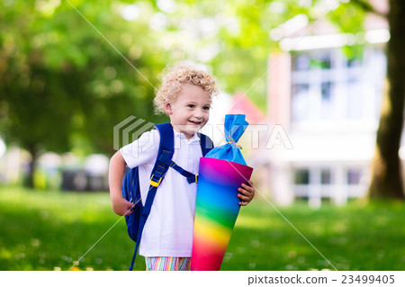 Little child with candy cone on first school day Little child with candy cone on first school day 23499405