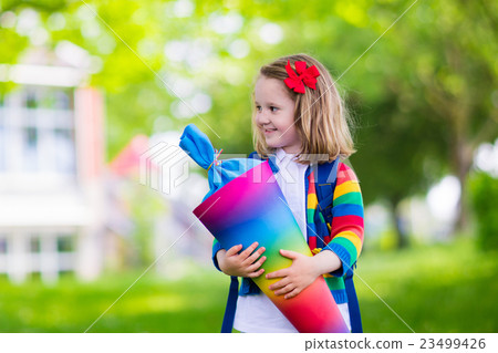 Little child with candy cone on first school day 23499426