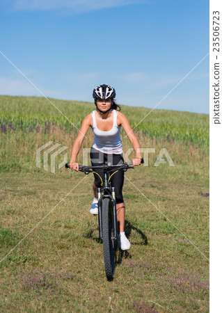 Happy Young Woman riding bicycle outside 23506723