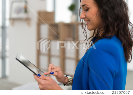 Portrait of an office manager holding her tablet 23507007