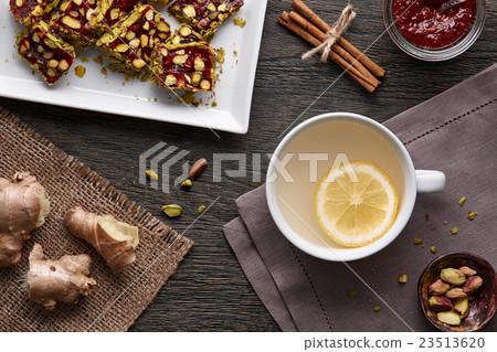Cup of ginger tea with lemon and turkish delight Cup of ginger tea with lemon and turkish delight 23513620