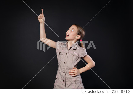 Small girl has idea. Child shows finger up, eureka 23518710
