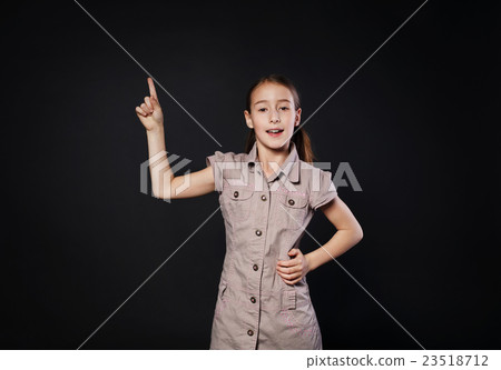 Small girl has idea. Child shows finger up, eureka 23518712
