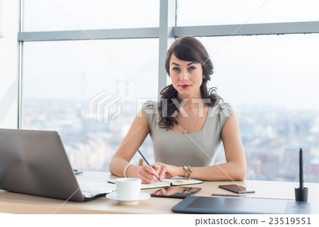 Side view portrait of a businesswoman sitting Side view portrait of a businesswoman sitting 23519551