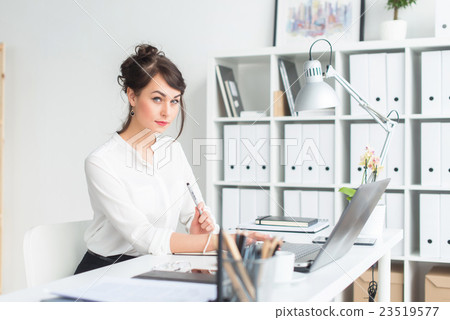 Close-up portrait of a businesswoman at her Close-up portrait of a businesswoman at her 23519577