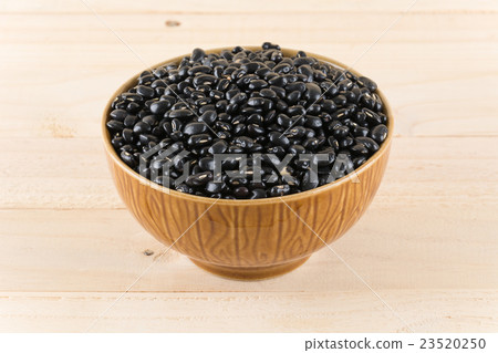 black beans on wood background 23520250