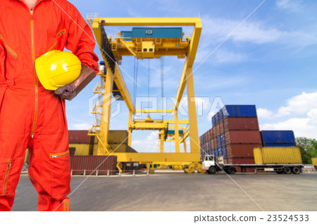 Asian engineers holding a yellow hardhat on Under construction four cranes with cloud on blue sky, constructure industrial concept Asian engineers holding a yellow hardhat on Under construction four cranes with cloud on blue sky, constructure industrial concept 23524533