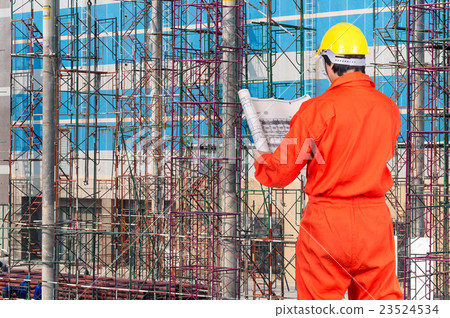 Portrait of Asian engineers looking at the blueprint on construction site workers, industrial construction concept Portrait of Asian engineers looking at the blueprint on construction site workers, industrial construction concept 23524534
