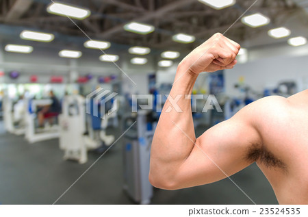 biceps on Abstract blurred photo of fitness gym background, sport healthy concept biceps on Abstract blurred photo of fitness gym background, sport healthy concept 23524535
