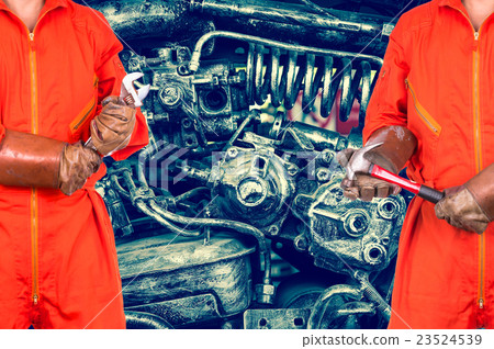 Engineers worker holding the tools on old machine steel or vintage spare part background, industry concept Engineers worker holding the tools on old machine steel or vintage spare part background, industry concept 23524539