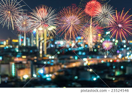Fantastic festive new years colorful fireworks on cityscape blurred photo bokeh in celebration night Fantastic festive new years colorful fireworks on cityscape blurred photo bokeh in celebration night 23524546