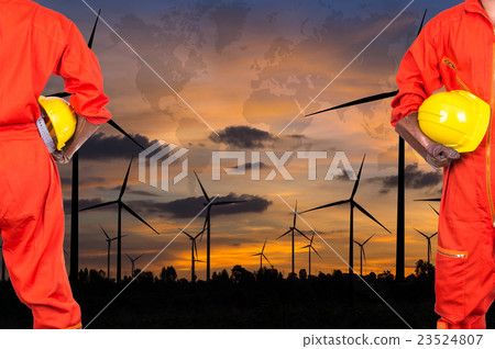Asian engineers holding a yellow hardhat on Wind turbine power generator with world map at twilight time, industrial concept, Elements of this image furnished by NASA 23524807