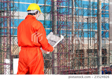 Portrait of Asian engineers looking at the blueprint on construction site workers, industrial construction concept Portrait of Asian engineers looking at the blueprint on construction site workers, industrial construction concept 23524926