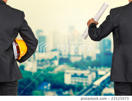 engineer in suit holding orange helmet and blueprint on abstract Blurred photo of sky train with cityscape background, business busy concept engineer in suit holding orange helmet and blueprint on abstract Blurred photo of sky train with cityscape background, business busy concept 23525073