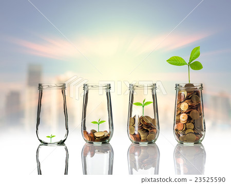 Gold coins and seed in clear bottle on cityscape photo blurred cityscape background,Business investment growth concept Gold coins and seed in clear bottle on cityscape photo blurred cityscape background,Business investment growth concept 23525590