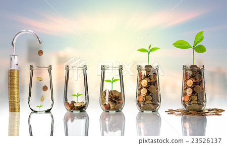 Faucet putting Gold coins and seed in clear bottle on cityscape photo blurred cityscape background,Business investment growth concept 23526137