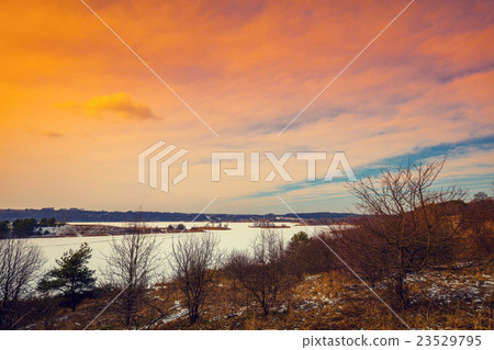 River bank in snowy winter at sunset River bank in snowy winter at sunset 23529795