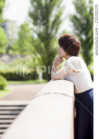 A young woman staring from the top of the bridge A young woman staring from the top of the bridge 23530220