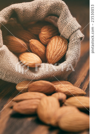 almonds in sack bag on wood table almonds in sack bag on wood table 23530853