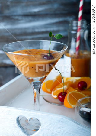 Orange cocktail with ice in a glass 23530914